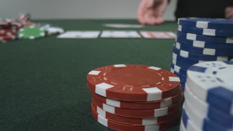 Sliding-Extreme-Close-Up-Shot-of-Poker-Player-Revealing-Pocket-Aces