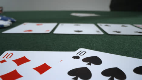 Sliding-Extreme-Close-Up-Shot-of-Poker-Player-Revealing-Pocket-Tens