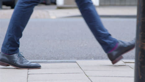 Medium-Shot-of-Pavement-as-Person-Walks-Along-It