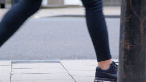 Medium-Shot-of-Pavement-as-Persons-Feet-Walk-Along-It