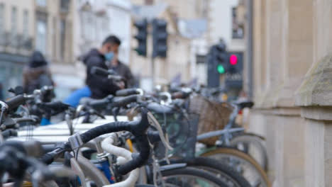 Defocused-Panning-Shot-Revealing-Bicycle-Rack-and-City-Pedestrians