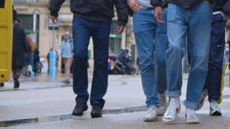 Sliding-Shot-of-Group-of-Pedestrians-Walking-Down-Street