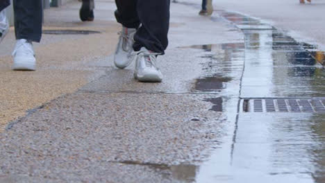 Sliding-Shot-of-Pedestrians-Feet-Walking-Down-City-Street