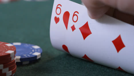 Extreme-Close-Up-Shot-of-Poker-Player-Checking-Their-Cards-