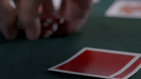 Extreme-Close-Up-Shot-of-Poker-Player-Looking-at-Seven-Deuce-Before-Bluffing