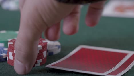 Extreme-Close-Up-Shot-of-Poker-Player-Looking-at-Seven-Deuce-Before-Bluffing