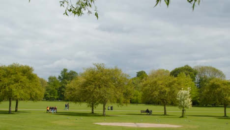 Sliding-Wide-Shot-of-People-In-Jesus-Park-