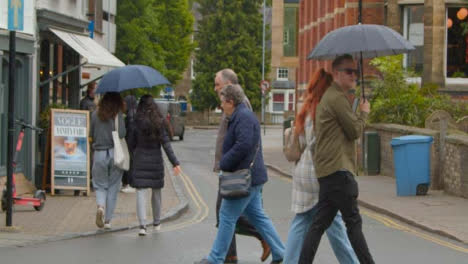 Wide-Shot-of-Pedestrians-Walking-In-Rain