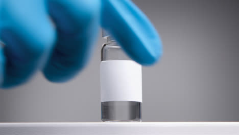 Low-Angle-Shot-Looking-Up-at-Vial-with-Clean-White-Label