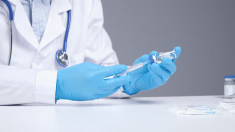 Medium-Shot-of-Medical-Professional-Extracting-Covid-19-Vaccine-from-Vial-Using-Syringe