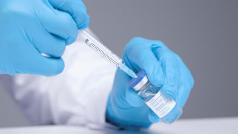 Close-Up-Shot-of-Medical-Professional-Extracting-Covid-19-Vaccine-from-Vial-Using-Syringe