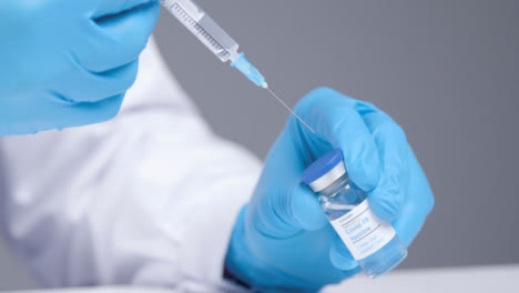 Close-Up-Shot-of-Medical-Professional-Extracting-Covid-19-Vaccine-from-Vial-Using-a-Syringe