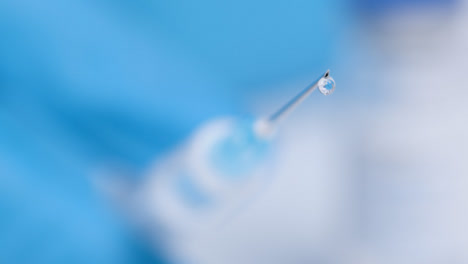 Pull-Focus-Shot-from-Covid-19-Vaccine-Vial-Label-to-Syringe-Needle-Tip