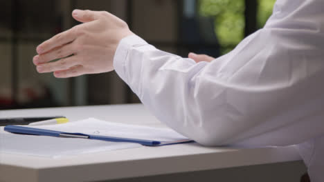 Sliding-Shot-of-Medical-Professionals-Hands-Gesturing-as-He-Talks