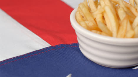 Extreme-Close-Up-Shot-of-Rotating-United-States-Flag-with-Bowl-of-Fries