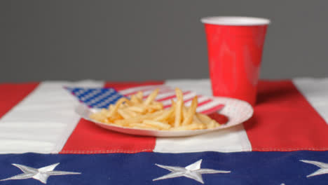 Sliding-Shot-Approaching-Plate-of-Fries-with-Red-Plastic-Beer-Cup