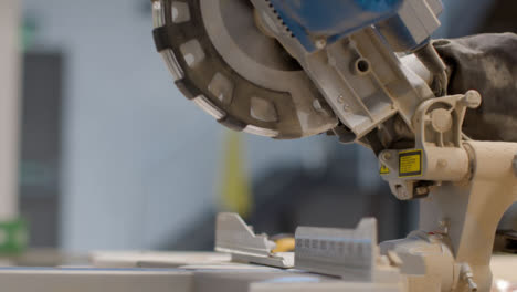 Handheld-Shot-of-Circular-Saw-Covered-In-Saw-Dust