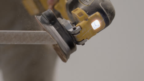 Extreme-Close-Up-Shot-of-Sander-Being-Used-On-Skirting-Board