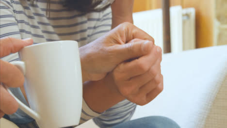 Close-Up-Shot-of-Middle-Aged-Couples-Hands-as-Husband-Tries-to-Comfort-Upset-Wife