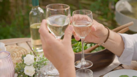 High-Angle-Shot-of-Middle-Aged-Couple-Bringing-Their-Wine-Glasses-Together