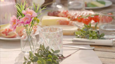 Pull-Focus-Shot-from-Glass-to-Alfresco-Dinner-Spread