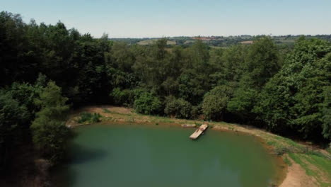 Drone-Shot-Flying-Low-Over-Trees-to-Reveal-Scenic-Lake-Part-1-of-2