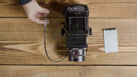 Top-Down-Shot-of-Person-Taking-Photo-with-Mamiya-RB67-Medium-Format-Film-Camera