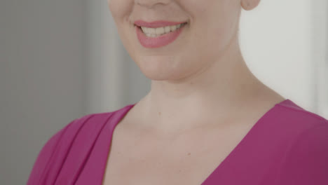 Close-Up-Shot-of-Model's-Mouth-as-She-Smiles-Off-Camera