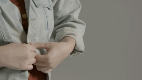 Close-Up-Shot-of-Female-Fashion-Model-Undoing-Denim-Jacket-Button