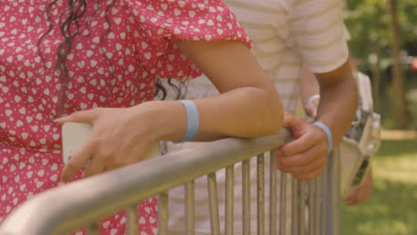 Close-Up-Shot-of-Festival-Goers-Hands-On-Securtiy-Barrier