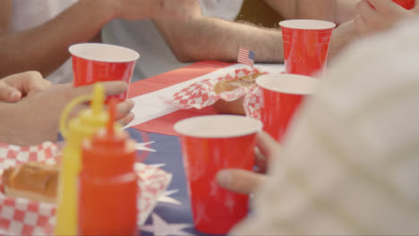 Over-the-Shoulder-Shot-of-Beer-Cups-On-Table-