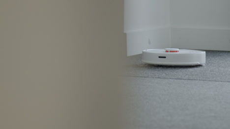 Long-Shot-of-Robotic-Vacuum-Cleaner-Cleaning-a-Carpet