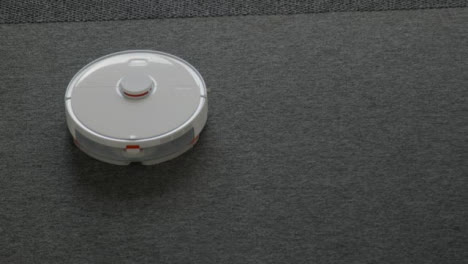 High-Angle-Shot-of-Robotic-Vacuum-Cleaner-Cleaning-Carpet