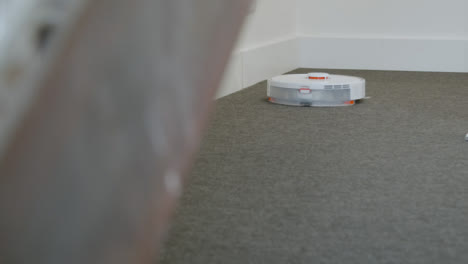 Long-Shot-of-an-Automatic-Robotic-Vacuum-Cleaner-Cleaning-Carpet