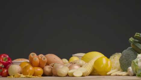 Sliding-Shot-Pulling-Away-from-a-Wood-Table-of-Fruit-and-Vegetables