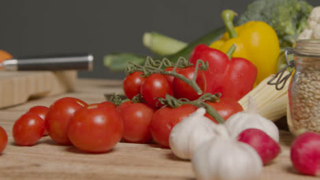 Tracking-Shot-from-Pile-of-Vegetables-to-Knife-On-Chopping-Board