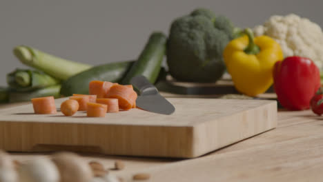 Tracking-Shot-Around-a-Rustic-Wooden-Table-with-Vegetables-On-It