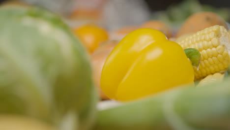 Close-Up-Shot-of-Yellow-Pepper-Amongst-Assorted-Vegetables-