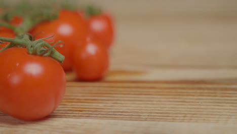Close-Up-Shot-of-Tomatoes-On-Rustic-Wood-Table-with-Copy-Space