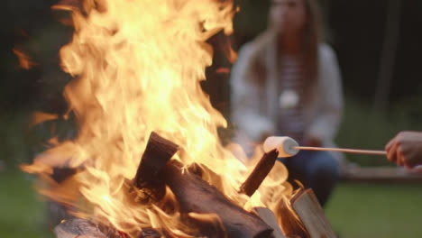 Close-Up-Shot-of-a-Marshmallow-On-a-Stick-In-a-Campfire