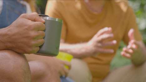 Close-Up-Shot-of-Hand-Holding-Cup-On-Camping-Trip