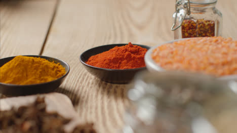 Tilt-Up-Shot-of-Spices-and-Grains-on-Table