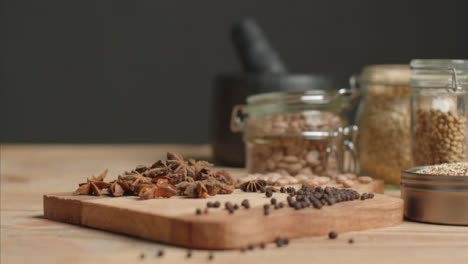 Sliding-Shot-Revealing-Spices-and-Grains-on-Rustic-Table