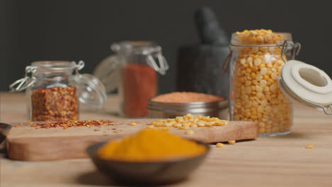 Tracking-In-Shot-of-Spices-to-Jar-of-Lentils-on-Table