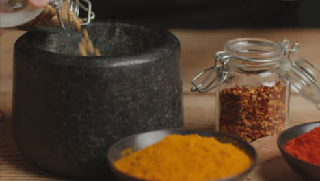 Tracking-In-Shot-Picking-Up-Cumin-to-Mortar-and-Pestle-on-Table