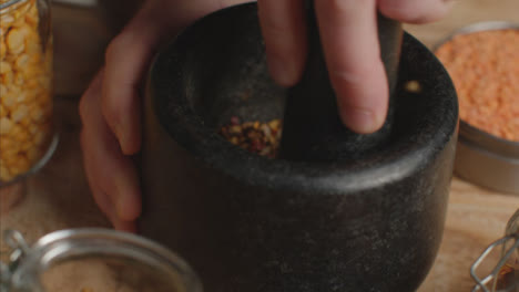 Overhead-Shot-Hand-Using-Mortar-and-Pestle-to-Grind-Spices