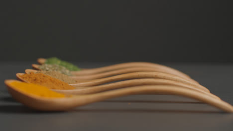 Tracking-In-Shot-of-Herbs-and-Spices-in-Wooden-Spoons