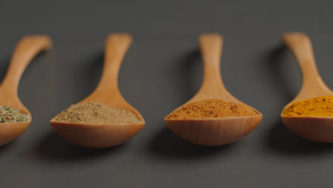 Close-Up-Sliding-Shot-of-Herbs-and-Spices-in-Wooden-Spoons