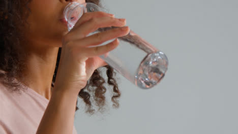 Close-Up-Shot-of-Young-Adult-Womans-Mouth-as-She-Drinks-from-Water-Bottle
