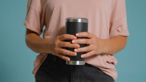 Close-Up-Shot-of-Young-Adult-Womans-Hands-Holding-Flask-01